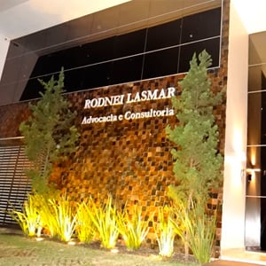 A iluminação da fachada do escritório de Goiânia/GO realça o paredão de pedras ferro. 